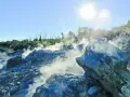 Fumarole attive nella valle del diavolo, con rocce grigie e blu avvolte dal vapore. Il sole splende nel cielo azzurro.