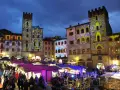 Mercatino natalizio ad Arezzo, con palazzi illuminati da proiezioni colorate. Vale la pena visitare Arezzo per questa magica atmosfera.