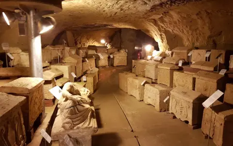 Antiche urne e sarcofagi etruschi, testimoni silenziosi del passato, esposti nel suggestivo ipogeo del Duomo di Chiusi.