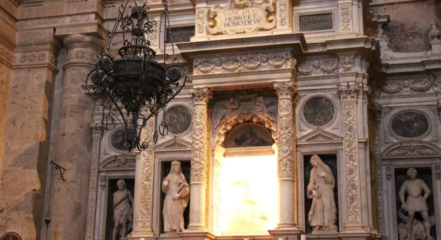 Interno della chiesa di San Biagio (Montepulciano): statue, affreschi e un lampadario in ferro battuto.