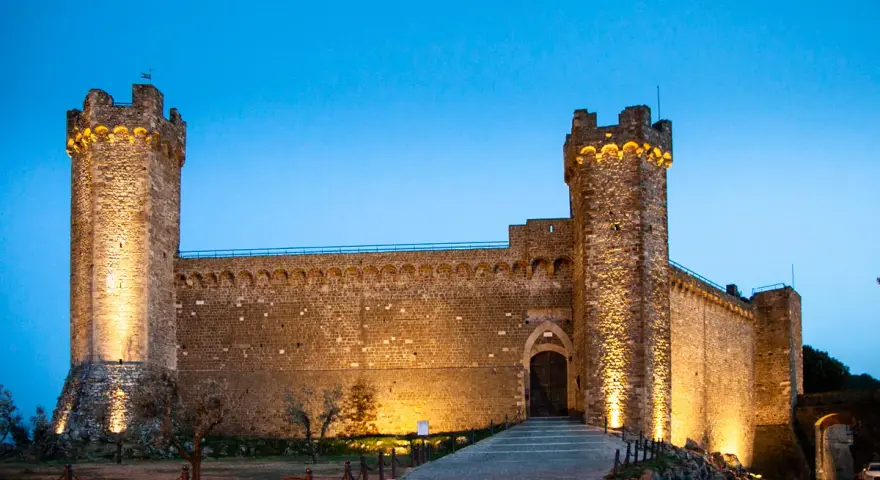 La Fortezza di Montalcino, illuminata di sera, è un luogo imperdibile da vedere.