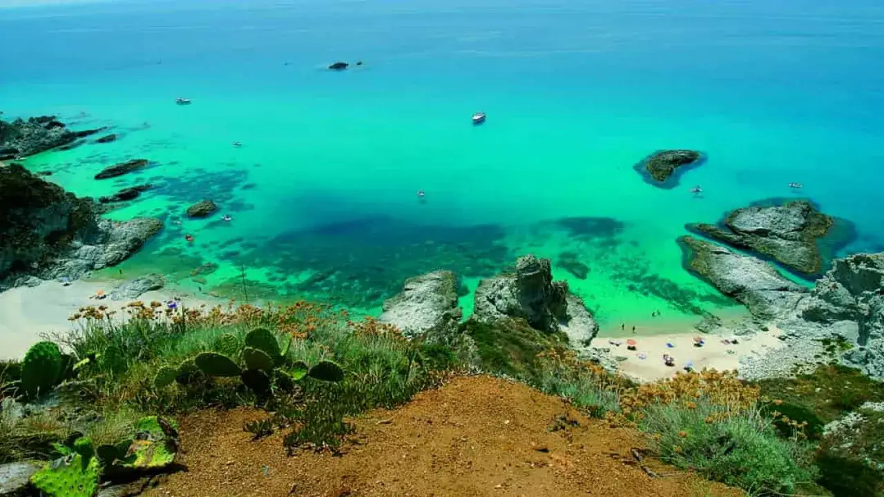Vista mozzafiato sulla Costa degli Dei: acque cristalline, spiagge dorate e scogliere rocciose. Un paradiso terrestre.