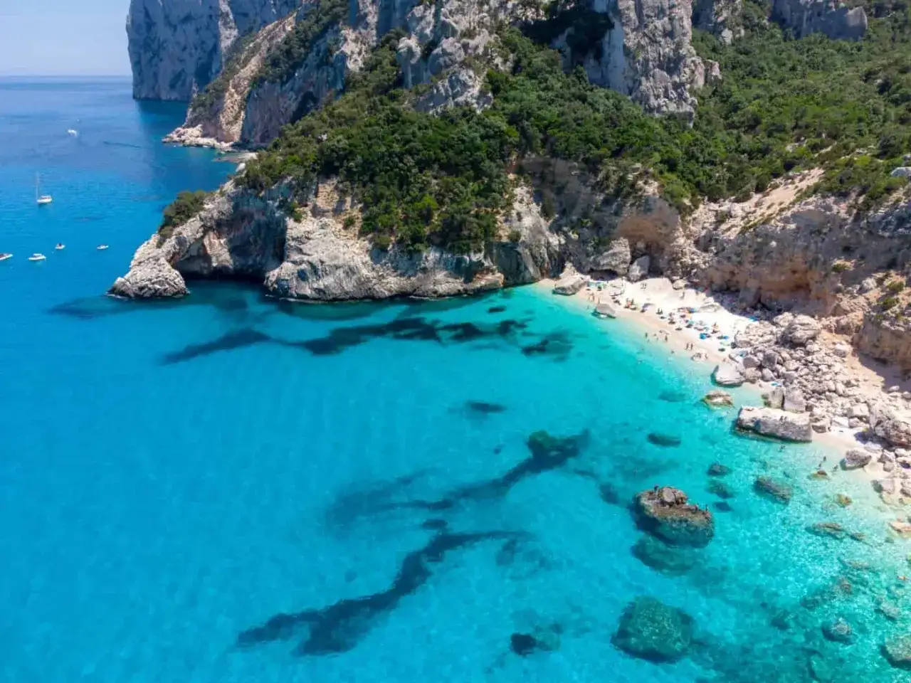 Acque cristalline e sabbia bianca: la spiaggia più bella d'Italia, incastonata tra scogliere imponenti e vegetazione rigogliosa.